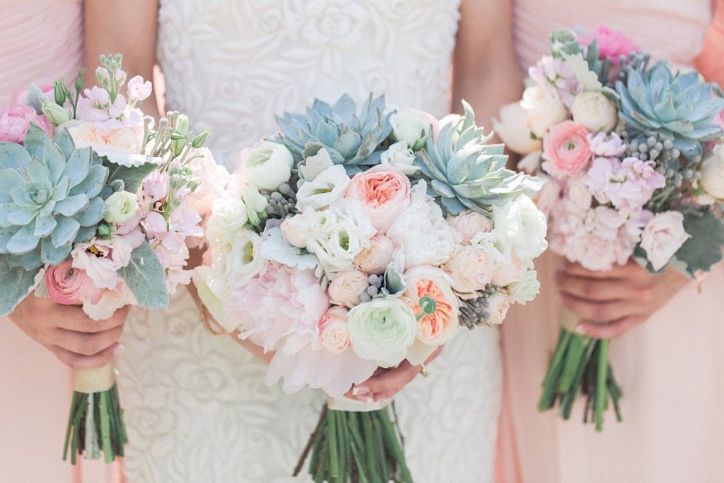 Bridesmaids with blush flowers and succulents by A Garden Party at a backyard wedding in New Jersey