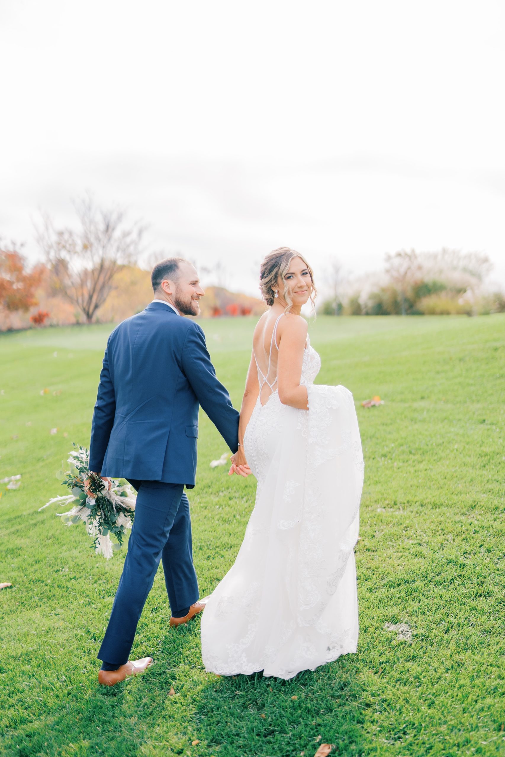 Bride and Groom hold hands at French Creek Golf Club Photos